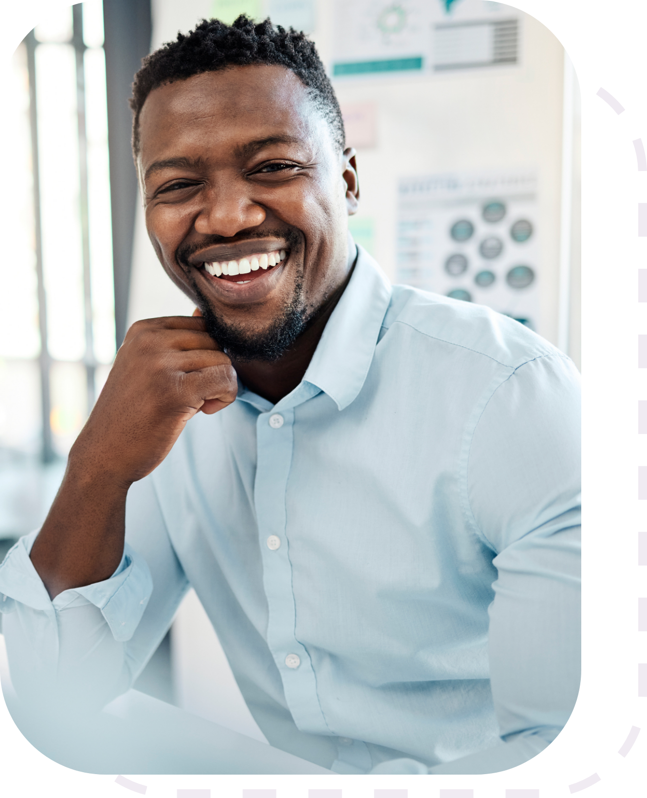 a man smiling at the camera in an office